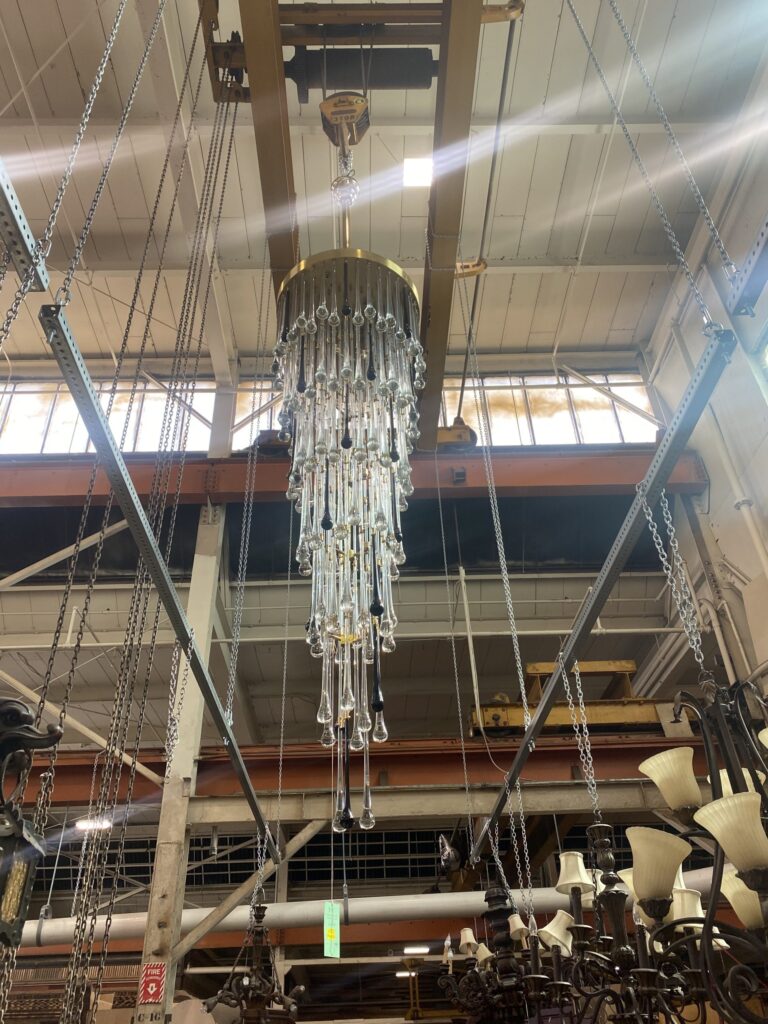 Large salvaged tiered chandelier with clear and black glass teardrop pendants, a unique secondhand lighting find at Second Chance, Baltimore's non-profit thrift retailer for building materials and vintage decor.
